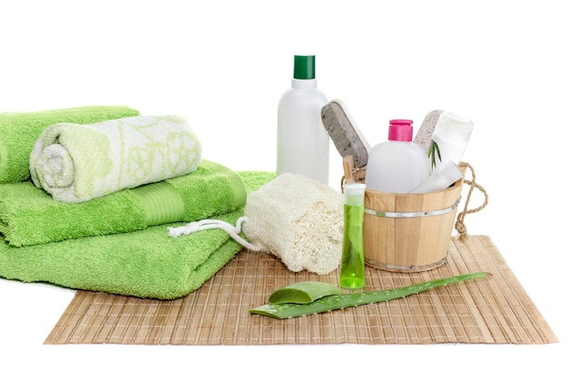 Spa still life Personal hygiene items green towels natural sponge and aloe leaves on a table closeup