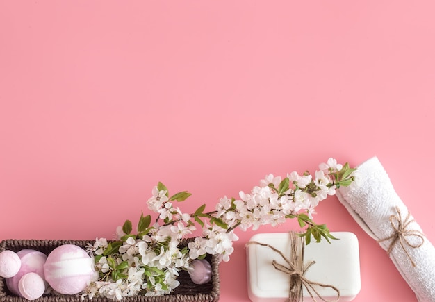 Spa still life on pink background with spring flowers