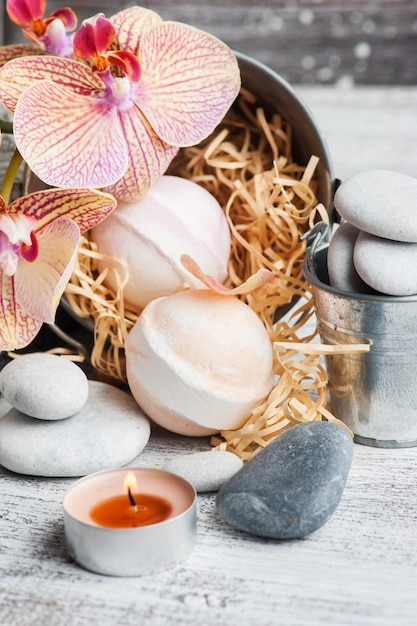 Photo spa still life with bath bombs and red orange orchid