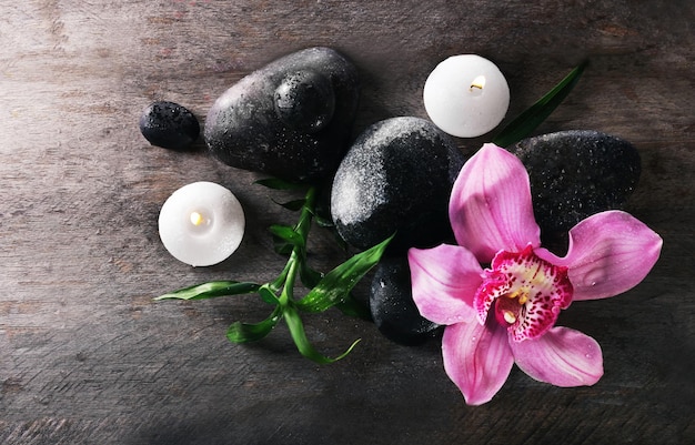 Spa still life with beautiful flower and candlelight on wooden background