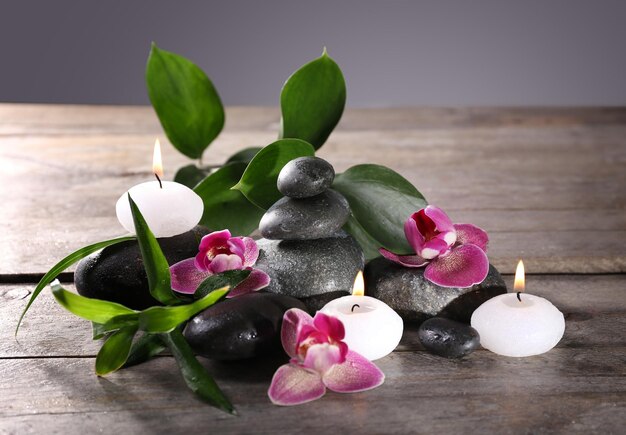 Spa still life with beautiful flower and candlelight on wooden table closeup