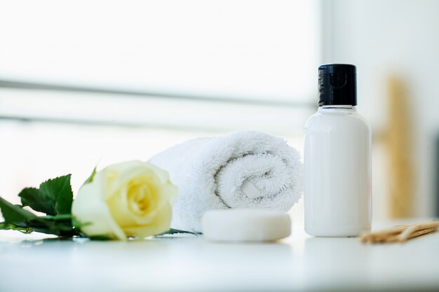 Spa still life with blossoms of white rose and essential oils