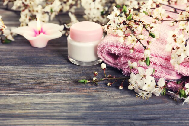 Spa still life with flowering branches on wooden background