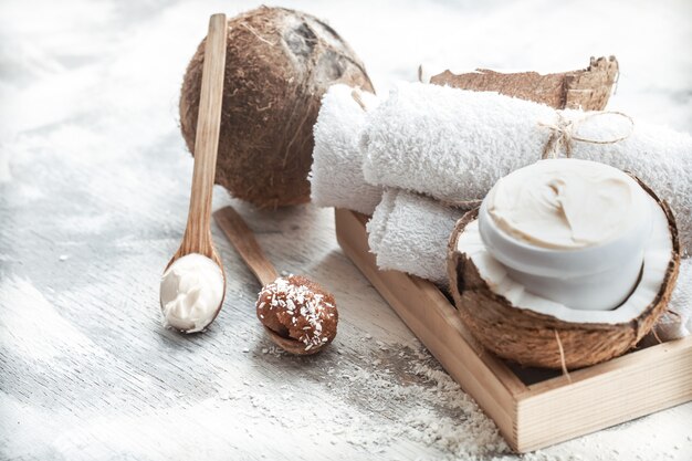 Spa still life with fresh coconut and body care products