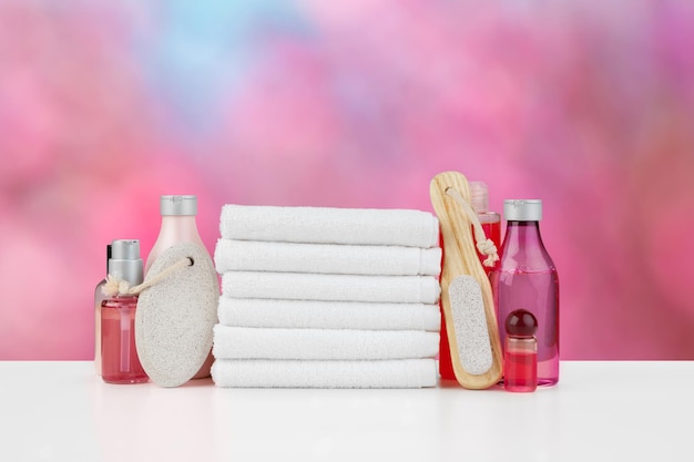 Spa still life with towels and skincare cosmetics against blurred background