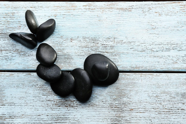 Spa stones drops on wooden background