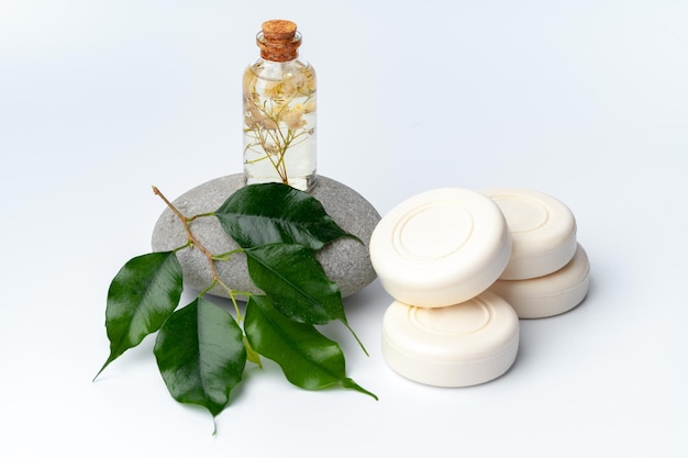 Spa stones and soap on white background