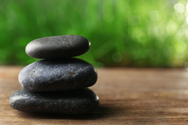 Spa stones on wooden table closeup