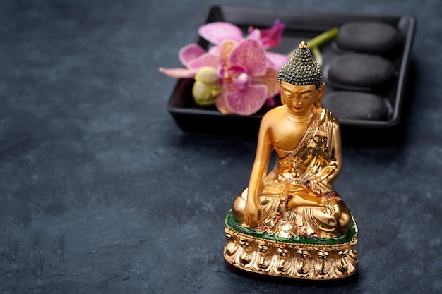 Spa Stones Zen Buddha statue and orchid flowers