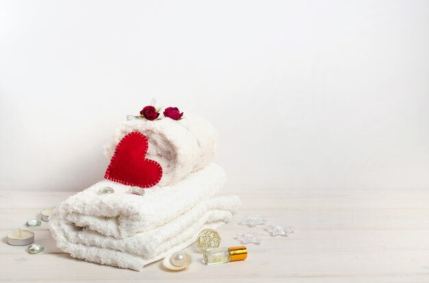 Spa treatment, massage as a gift on Valentine's Day with copy space on a white background. For beauty salons.