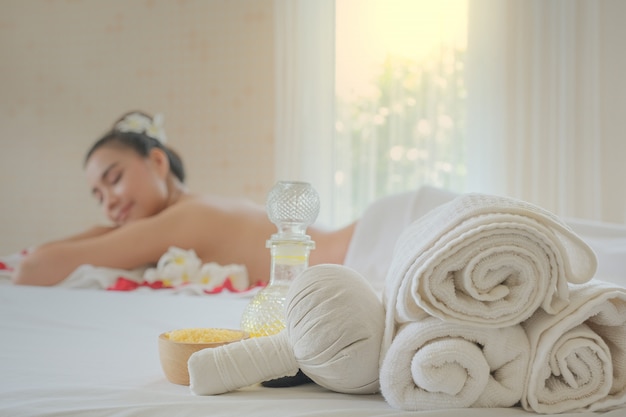 Spa treatment set and aromatic massage oil on bed massage