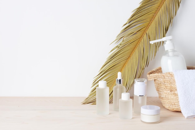 spa treatment with natural skin care products towel and basket on white background close up copy space