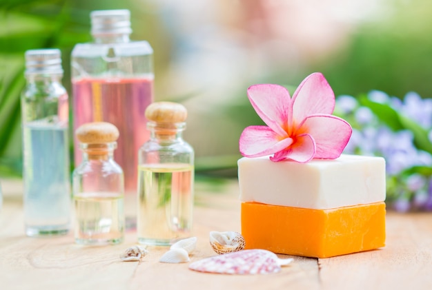 Photo spa treatment with scented candles and soap on wood.