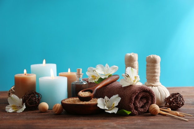 Spa treatments on wooden table against blue