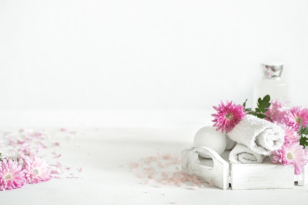 Spa wall with products for personal hygiene and beauty with pink flowers. Hygiene and body care concept.