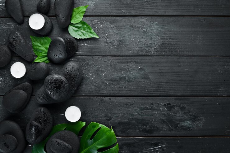 Spa Wellness Relax concept Black stones and accessories for massages and SPA Top view Free space for your text
