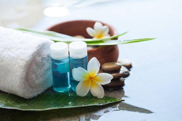 Photo spa or wellness setting with tropical flower body care and spa concept on black background