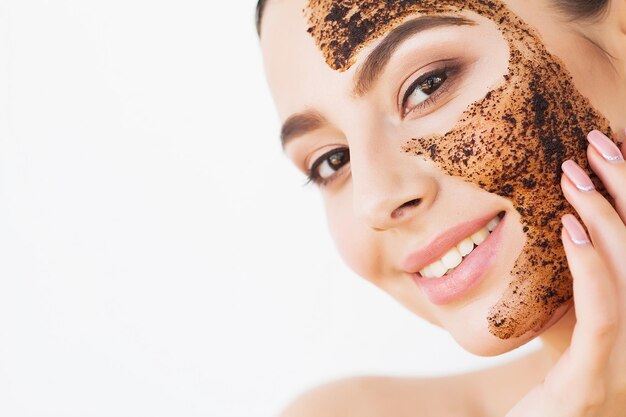 Spa Woman applying Facial cleansing Mask