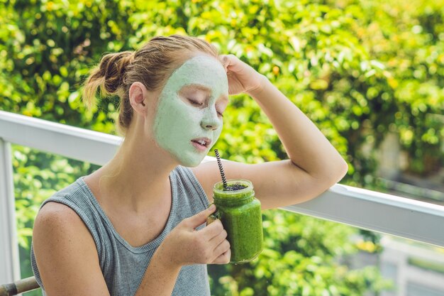 Spa Woman applying Facial green clay Mask.