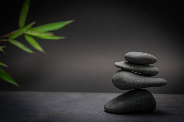 Spa zen basalt stones and green bamboo leaves Wellness relaxation massage