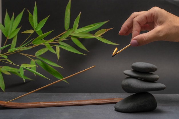 Spa zen basalt stones and green bamboo leaves wellness\
relaxation massage