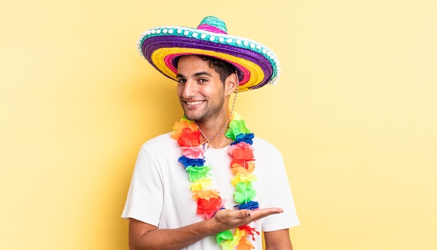 Spaanse knappe man die vrolijk lacht, zich gelukkig voelt en een concept toont. Mexicaans feestconcept