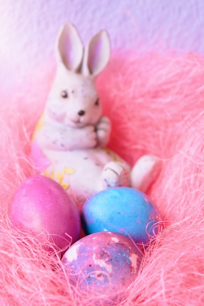 Space galactic Easter eggs in a pink nest next to a bunny