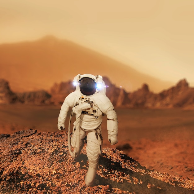 Space man astronaut walks on the red planet Mars. Man travels to Mars. Astronaut landing in the red desert