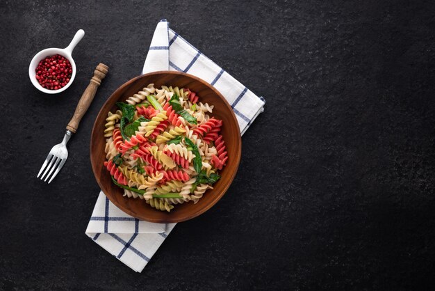 Space vegan colour pasta on wood plate