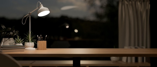 a space on a wooden tabletop in a contemporary room at night illuminated by a table lamp