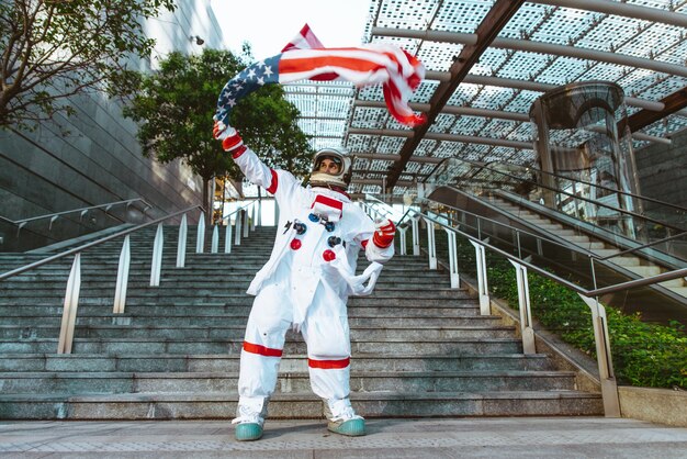 Spaceman in a futuristic station. Man with space suit walking in an urban area