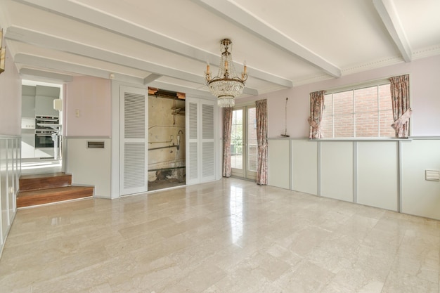 Spacious bright empty room with chandelier