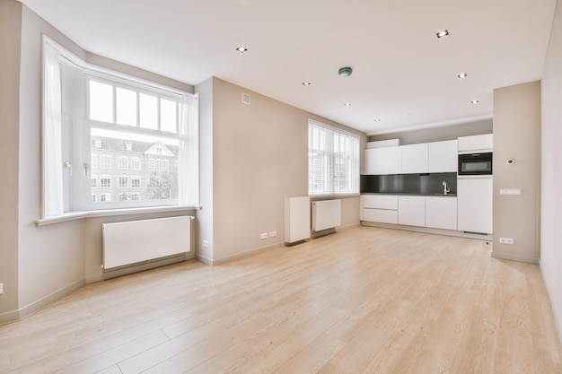 Spacious bright white kitchen with windows