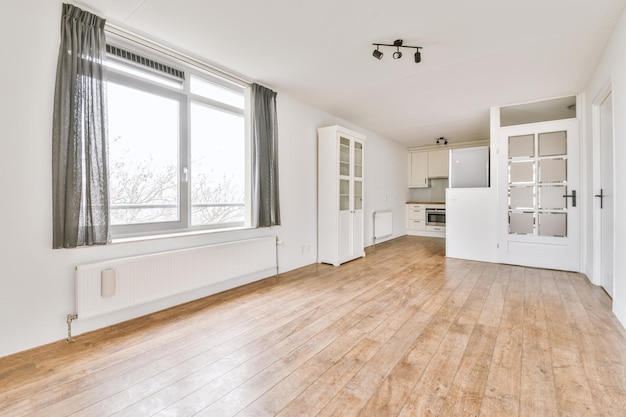 Spacious bright white kitchen with windows