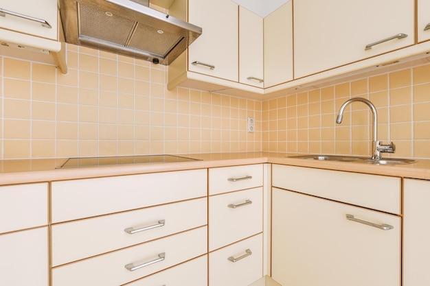 Spacious bright yellowish kitchen with windows