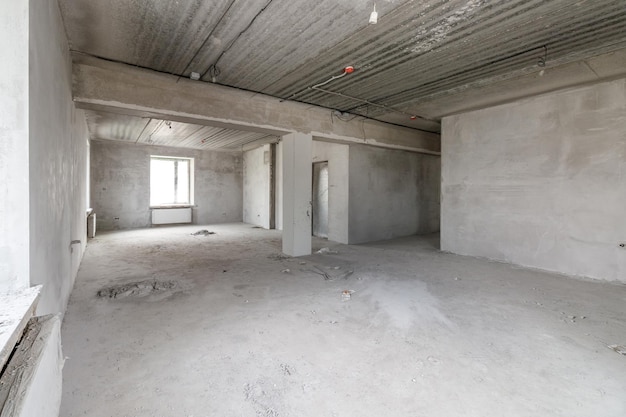 Spacious empty rooms in the attic floor after filling out the work on the wall and ceiling