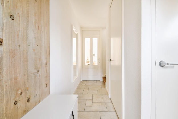 Spacious hallway with tiled floor and entrance to the cozy house