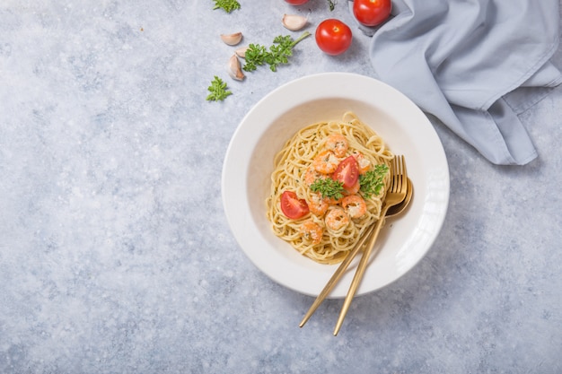Spagetti marinara with shripms.  pasta dish on grey concrete  table