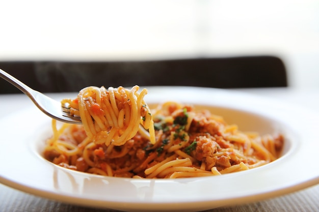 Spaghetti bolognese meat sauce on wood