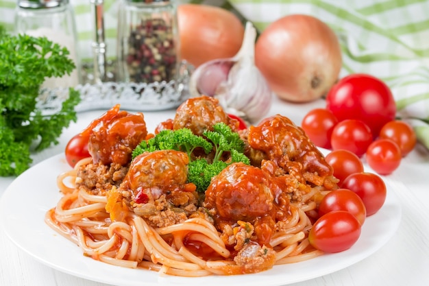 Spaghetti bolognese with beef meatballs and parsley