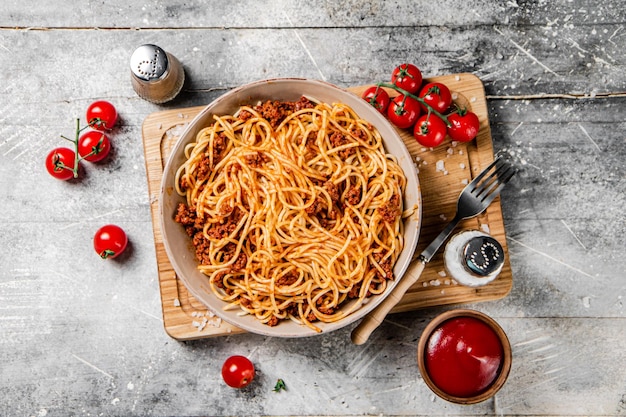 Spaghetti bolognese with cherry tomatoes on the table