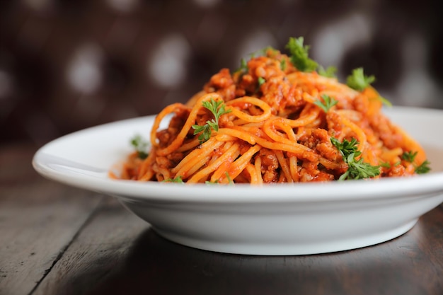 Spaghetti bolognese on wood background , italian food