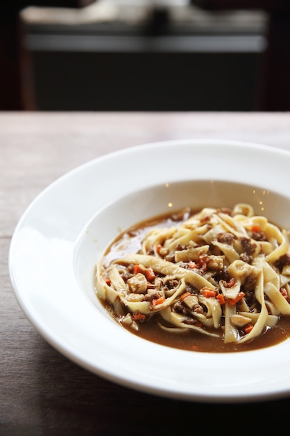 Spaghetti bolognese on wood background