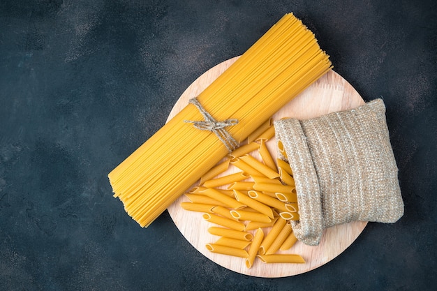 Spaghetti on a brown concrete background.