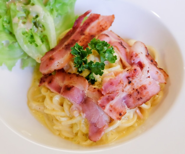 Spaghetti carbonara sauce and bacon.