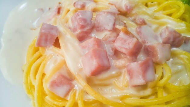 Spaghetti carbonara with cream close up image.