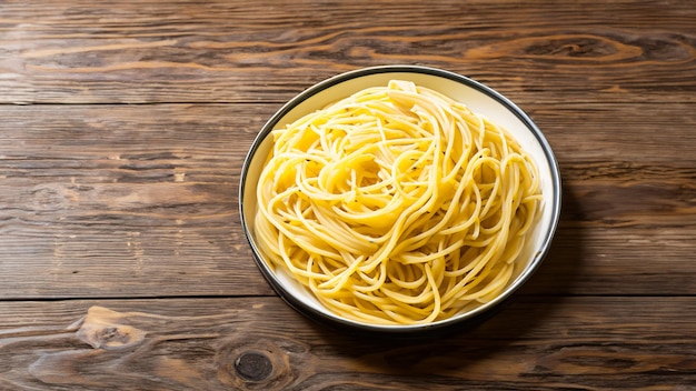 Spaghetti in a dish on a wooden background