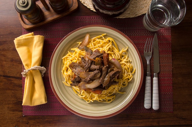 Spaghetti huancaina sauce and lomo saltado Peru peruvian comfort food mise en place wooden table