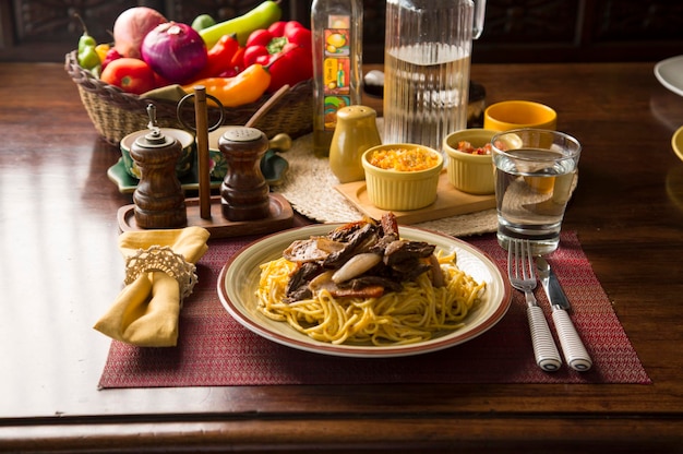 Spaghetti huancaina sauce and lomo saltado Peru peruvian comfort food mise en place wooden table