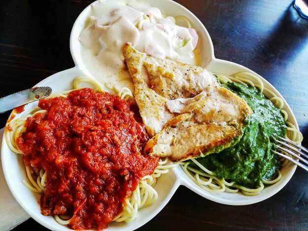 Spaghetti met drie sauzen van verschillende smaken en gegrilde kip